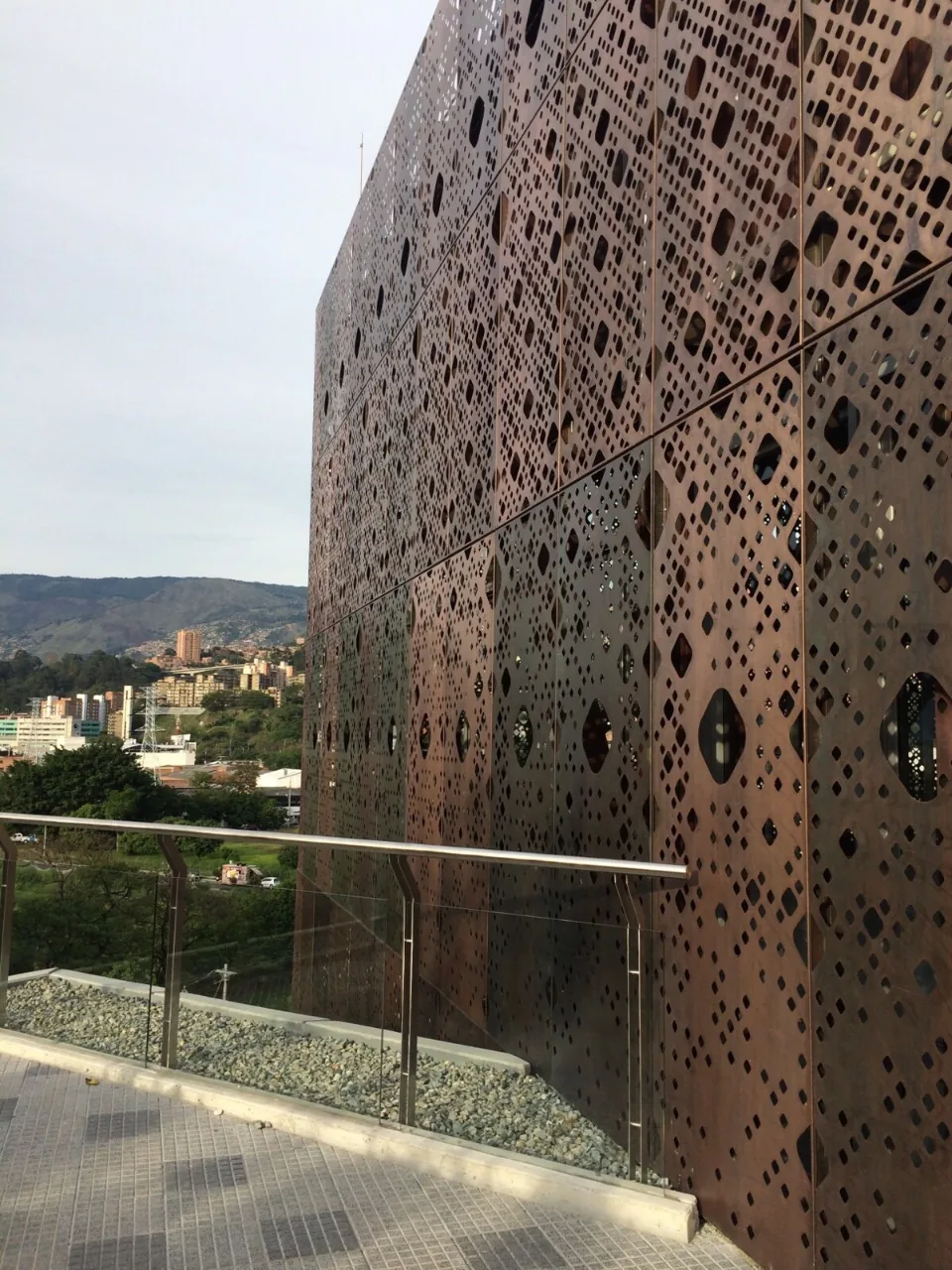 Close view of perforated metal facade finish and pattern