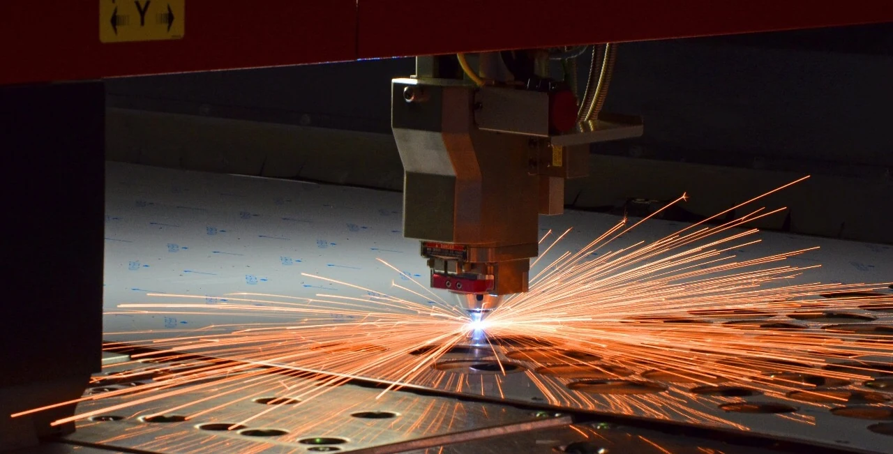Laser cutting architectural metal panels during fabrication