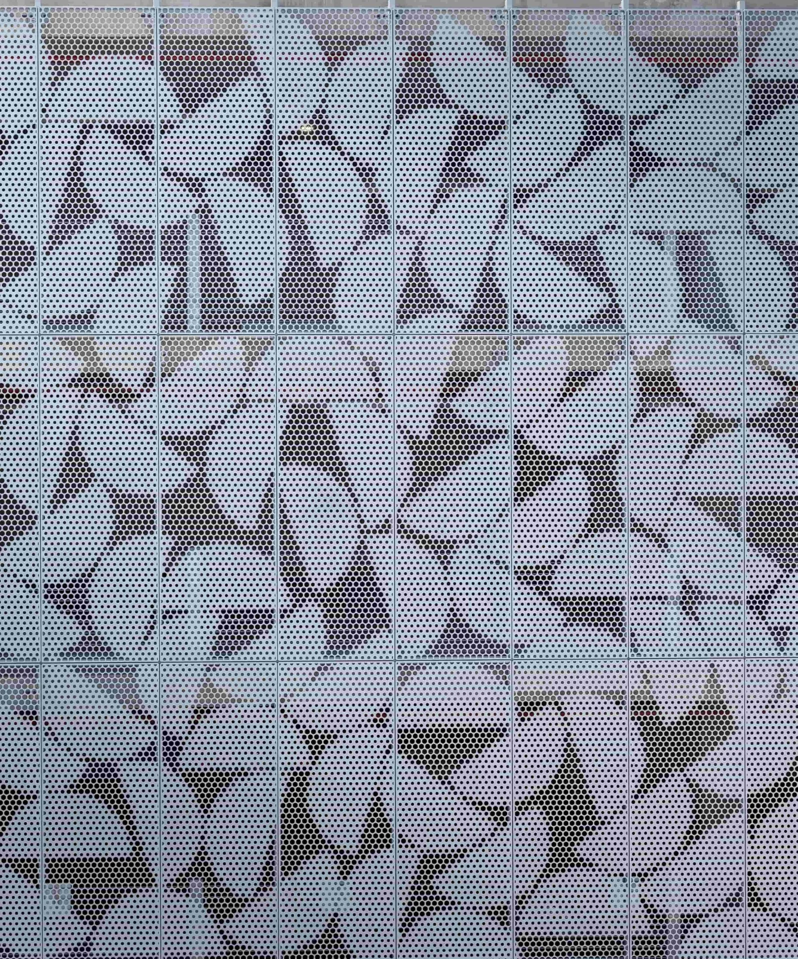 White perforated architectural image panel with custom pattern